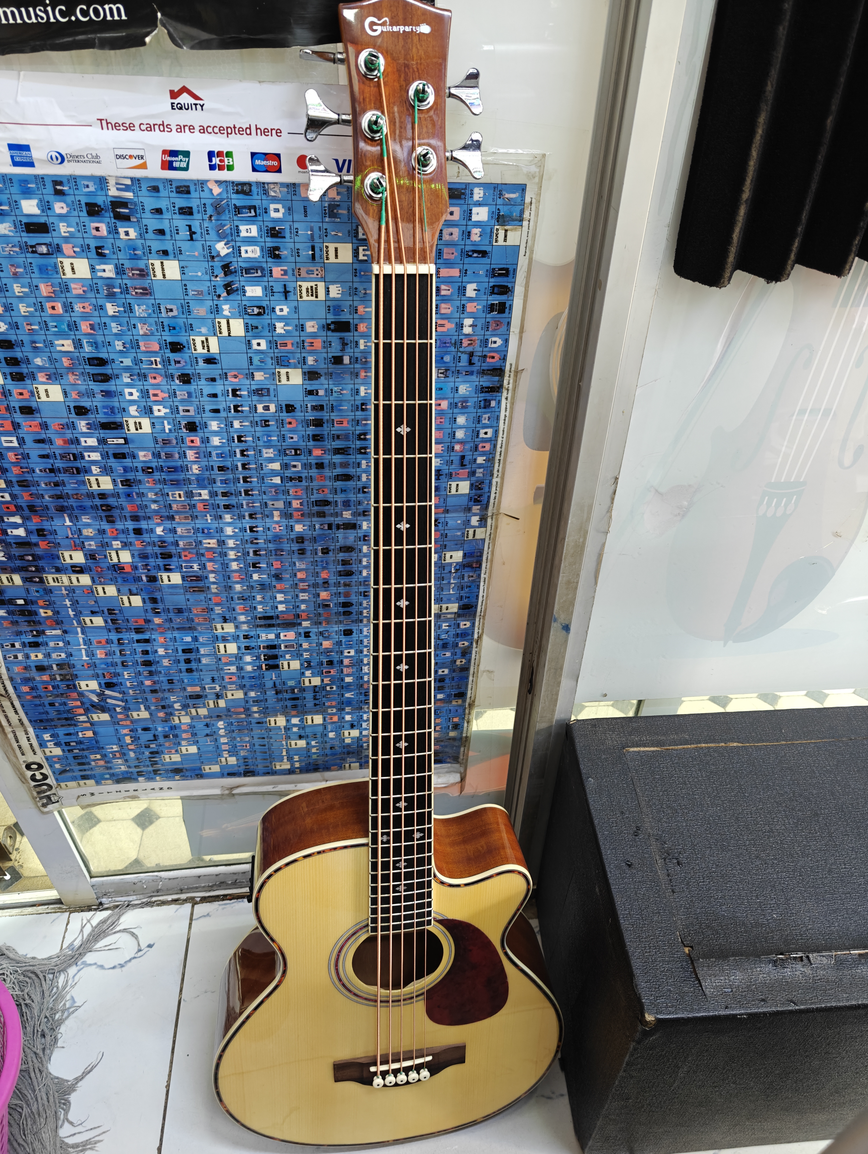 Full-size 5-string acoustic bass guitar with cutaway body, built-in EQ preamp, natural wood finish, and extended low B string for live performance and recording